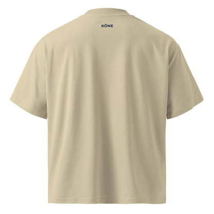 Vista trasera de la camiseta beige KÖNE con corte oversize y tejido orgánico